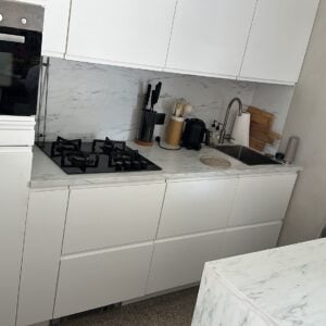 Moderne mat witte greeploze eilandkeuken